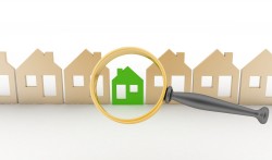 Magnifying glass selects or inspects a eco-home in a row of houses. Concept of search of house for residence, real estate investment, inspection.